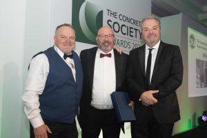 Steve Davies (left) and Hal Cruttenden (right) present Paul Russell with the Concrete Society Repair & Refurbishment Award for Saltdean Lido